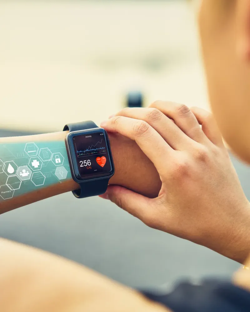 Young woman checking the sports watch with screen healthcare icon,  measuring heart rate and performance after running.